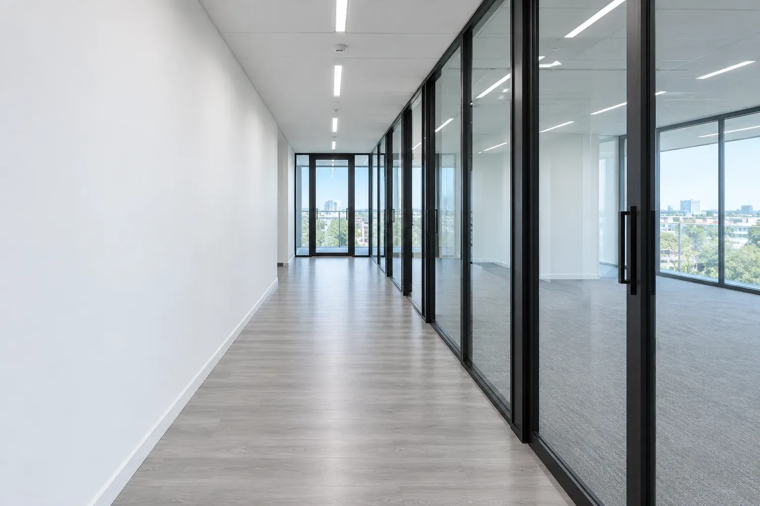 The same corridor after the clean: glazing clear, frames clean, floor swept and buffed