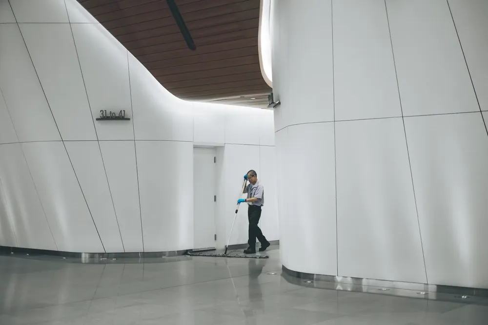 Cleaner working through a modern commercial interior